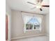 Bedroom with window, curtains, ceiling fan and neutral paint at 5133 Greenard Watson Lane, Buford, GA 30518