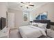 Neutrally decorated bedroom with plush carpet, large window, and an entertainment center at 5133 Greenard Watson Lane, Buford, GA 30518