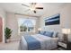 Serene bedroom with a ceiling fan, bright window, plush carpeting, and stylish decorations at 5133 Greenard Watson Lane, Buford, GA 30518