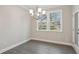 Cozy dining area with a chandelier and natural light from the exterior view at 5133 Greenard Watson Lane, Buford, GA 30518