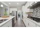 Contemporary kitchen with stainless steel appliances, center island, and stylish backsplash at 5133 Greenard Watson Lane, Buford, GA 30518