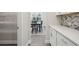 Pantry and view of the dining room with wood floors and a modern chandelier at 5133 Greenard Watson Lane, Buford, GA 30518