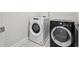 Modern laundry room with front load washer and dryer at 5133 Greenard Watson Lane, Buford, GA 30518