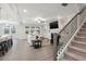 Spacious living room with fireplace, TV, stairs, and adjacent kitchen area at 5133 Greenard Watson Lane, Buford, GA 30518