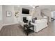 Open living room with fireplace, large TV, and hardwood floors at 5133 Greenard Watson Lane, Buford, GA 30518