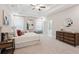 Bright main bedroom featuring a tray ceiling, ensuite bath, neutral palette and stylish furnishings at 5133 Greenard Watson Lane, Buford, GA 30518