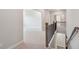 Second floor hallway featuring wood and metal staircase at 5133 Greenard Watson Lane, Buford, GA 30518