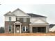 Two-story house with gray brick and beige siding, a three-car garage, and a covered entryway at 3121 Morris Hills Dr, Dacula, GA 30019