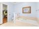 Bathroom with soaking tub, walk-in closet, and light blue walls at 3657 Peachtree Ne Rd # 2C, Atlanta, GA 30319