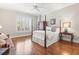 Spacious bedroom with hardwood floors and a four-poster bed at 3657 Peachtree Ne Rd # 2C, Atlanta, GA 30319