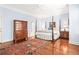 Bedroom with hardwood floors, a four-poster bed, and ample closet space at 3657 Peachtree Ne Rd # 2C, Atlanta, GA 30319