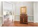 Elegant hallway with hardwood floors, antique furniture, and views into a living area at 3657 Peachtree Ne Rd # 2C, Atlanta, GA 30319