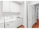 Laundry room with washer, dryer, and white cabinets at 3657 Peachtree Ne Rd # 2C, Atlanta, GA 30319