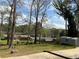 Expansive backyard with mature trees and a shed, offering ample space for recreation at 6595 Malvin Dr, Austell, GA 30168