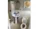 Bathroom featuring a pedestal sink, a toilet, and white tiled walls at 6595 Malvin Dr, Austell, GA 30168