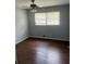 Cozy bedroom with hardwood floors and natural light from the window at 6595 Malvin Dr, Austell, GA 30168