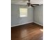 Neutral bedroom features wood-look flooring and a ceiling fan at 6595 Malvin Dr, Austell, GA 30168