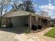 Traditional brick home with a carport, manicured lawn, and mature landscaping at 6595 Malvin Dr, Austell, GA 30168