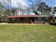 Traditional brick house features a lush front yard and inviting walkway to the front door at 6595 Malvin Dr, Austell, GA 30168