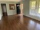 Inviting living room featuring beautiful hardwood floors, neutral walls, and a bright window at 6595 Malvin Dr, Austell, GA 30168