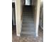 Stairway featuring carpeted steps and wooden hand rail at 6595 Malvin Dr, Austell, GA 30168