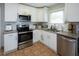 Modern kitchen with white cabinets, granite countertops and stainless steel appliances at 2278 Smith Sw Ave, Marietta, GA 30064