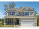 Inviting two-story home with stone accents, covered front porch, and attached two-car garage at 2599 Windsor Knoll Dr, Dacula, GA 30019