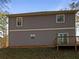 Exterior rear view of a two-story home featuring a small deck at 60 Hammock Dr, Covington, GA 30016