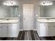 Bathroom featuring double vanities with granite countertops and a walk-in shower at 60 Hammock Dr, Covington, GA 30016