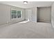 This bedroom offers neutral walls, plush carpet, natural light from a window, and ample space at 60 Hammock Dr, Covington, GA 30016