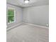 Bedroom featuring neutral-colored carpet, a window, and ample space at 60 Hammock Dr, Covington, GA 30016