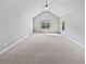 Spacious bedroom with vaulted ceiling, large windows, and neutral carpet at 60 Hammock Dr, Covington, GA 30016