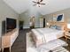 Relaxing bedroom features a vaulted ceiling, neutral decor, and plush carpet at 60 Hammock Dr, Covington, GA 30016
