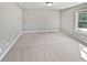 Bedroom featuring neutral-colored carpet, a window, and ample space at 60 Hammock Dr, Covington, GA 30016
