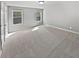 Bedroom featuring neutral-colored carpet, two windows, and ample space at 60 Hammock Dr, Covington, GA 30016