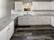 Bright kitchen with white cabinets, granite countertops, stainless steel appliances, and hardwood floors at 60 Hammock Dr, Covington, GA 30016