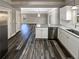 Open kitchen featuring white cabinets, granite countertops, and dark hardwood flooring at 60 Hammock Dr, Covington, GA 30016