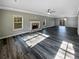 Spacious living room featuring a fireplace, crown molding, and wood-look flooring at 60 Hammock Dr, Covington, GA 30016