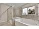 Bathroom featuring a walk-in shower and a soaking tub at 147 Stargaze Rdg, Canton, GA 30114
