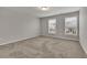 Light-filled carpeted bedroom featuring two bright windows at 147 Stargaze Rdg, Canton, GA 30114
