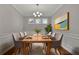 Charming dining room with table set for a dinner party and decorative painting at 147 Stargaze Rdg, Canton, GA 30114