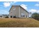 Back exterior of home with a grassy hillside at 147 Stargaze Rdg, Canton, GA 30114