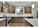 A modern kitchen with stainless steel appliances, light countertops, and hardwood floors at 147 Stargaze Rdg, Canton, GA 30114