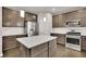 Spacious kitchen with stainless steel appliances, an island, and ample cabinet storage at 147 Stargaze Rdg, Canton, GA 30114