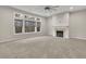 Large, empty living room with fireplace and many windows offering views of nature at 147 Stargaze Rdg, Canton, GA 30114