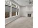A spacious living room with a fireplace, large windows, and natural light at 147 Stargaze Rdg, Canton, GA 30114
