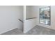 Hallway and staircase featuring plush carpeting and natural light from the window at 811 Wynnes Ridge Se Cir, Marietta, GA 30067