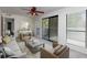 Comfortable living room featuring neutral tones, a ceiling fan, and a sliding glass door to a balcony at 811 Wynnes Ridge Se Cir, Marietta, GA 30067