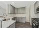 Modern kitchen with gray cabinets, white subway tile backsplash, and stainless steel appliances at 539 Easton Dr, Locust Grove, GA 30248