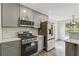 Modern kitchen featuring stainless steel appliances and gray cabinets at 539 Easton Dr, Locust Grove, GA 30248